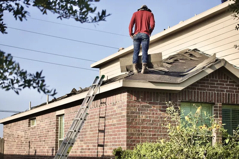 Professional roofer working on a residential roof in Dietrich